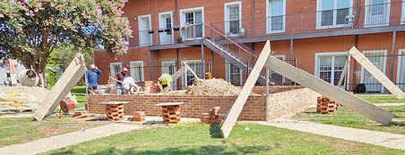 Workers lay bricks for the foundation of the new pavilion at Veterans Park in downtown Welsh. Officials are seeking donations to help fund the project. Submitted photo