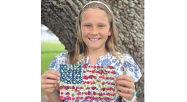 Local fourth grader Etta Landry proudly displays her work of art symbolizing what America means to her. The elementary student is the daughter of Ben and Amber Landry, the granddaughter of Tony and Sharon Comeaux, Todd and Sandy Landry and the great-granddaughter of Albert and Linda Wilson and Mary Landry, all of Jennings. Submitted photo