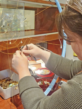 Creative Circle member Bailey G. Landry works on her sculpture for the community art exhibit for Steel Magnolias. Landry is one of the artists who contributed art for the display. Daily News photo by Erin Hargrave