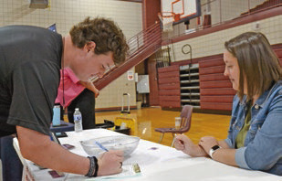 Welsh High School student Alek Gay, 18, (left) and Jeff Davis Parish Registrar of Voters Assistant Jenee Lavergne