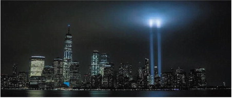 Two beams of light rise above the New York City skyline, memorializing the site of the fallen twin towers. Photo: Olga Subach / Unsplash