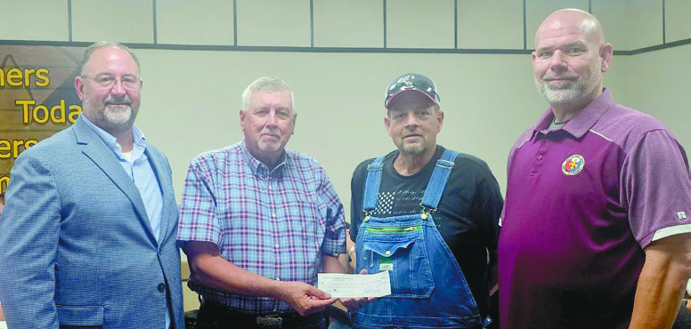 The Jeff Davis Cattleman’s Association donated $6,000 to the Jeff Davis Parish School Board to be evenly divided between the six high school FFA chapters in the parish. Shown during the presentation of the check are Superintendent John Hall (from left), JDCA President Richard Carter, JDCA member Brandon Broussard and JDSB President Greg Patterson. Carter said each chapter can use the funds as they see fit. Daily News photo by Erin Hargrave