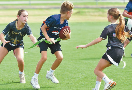 Young players participate in the opening day of the community flag football league, Next Play in Welsh. The athletes are developing their skills while enjoying a fun, active season with family and friends cheering them on. Daily News photos by Renee Benoit