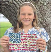 Local fourth grader Etta Landry proudly displays her work of art symbolizing what America means to her. The elementary student is the daughter of Ben and Amber Landry, the granddaughter of Tony and Sharon Comeaux, Todd and Sandy Landry and the great-granddaughter of Albert and Linda Wilson and Mary Landry, all of Jennings. Submitted photo