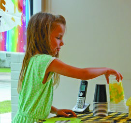 Families recently gathered at the McBurney Memorial Library in Welsh for a bit of fun and make believe. Library Manager Jean Stoute set up stations for attendees, including a coffee shop, lemonade stand, burger joint, optometrist clinic and a Lego table. Stoute said the Together Time activity is a favorite of many library patrons. Farah Meche (left), 5, preps lemonade for her customers. Meche said she enjoys playing pretend.