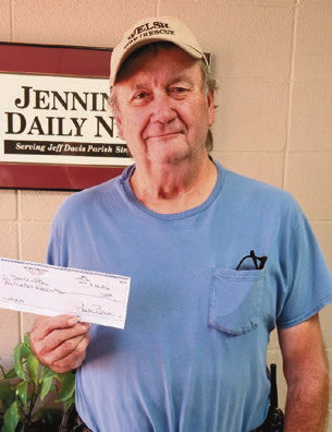 Donnie Lebleu of Welsh collects his prize for correctly guessing the winning football teams in the annual Jenning Daily News You Pick Em contest. Lebleu received a $100 for his winning entry. Daily News photo by Jennifer Mouhot