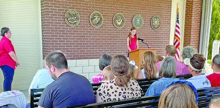 Children, including Ariana Gary (above) and Hattie Landry (below), veterans and families participate in the Memorial Day ceremony at the Southwest Louisiana Veterans Cemetery, where community members honored fallen service members while also remembering the late cemetery director Dwayne Guidry and his lasting commitment to preserving veterans’ legacies. Daily News photos by Darcy Knight