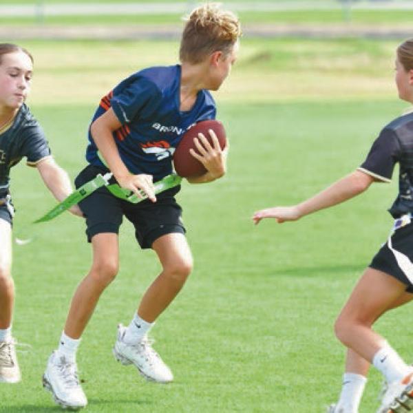 Young players participate in the opening day of the community flag football league, Next Play in Welsh. The athletes are developing their skills while enjoying a fun, active season with family and friends cheering them on. Daily News photos by Renee Benoit