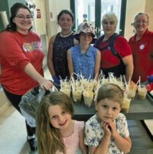 Vice President Madison Kershaw (top, from left), junior member Danica Young, junior member Dustina Young, President Debbie Hebert, Sergeant at Arms Terry LaFleur, junior member Madilyn Kershaw (bottom, from left) and junior member Michael Kershaw serve up the floats. Submitted photos