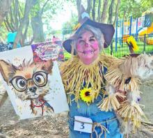 Money Daggett and her four-legged sidekick take the scarecrow theme all the way during Boo on the Avenue in Lake Arthur. The pair were among the winners of the event’s costume contests.