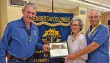 Grand Knight Mason LeJeune (from left) with Janet and Preston Doucet