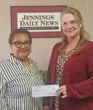 Agnes Allen of Jennings (left) receives her $50 check from Classifieds Manager Jennifer Mouhot. Allen correctly guessed the winning football teams in the Jennings Daily News You Pick Em weekly contest. Daily News photo by Erin Hargrave