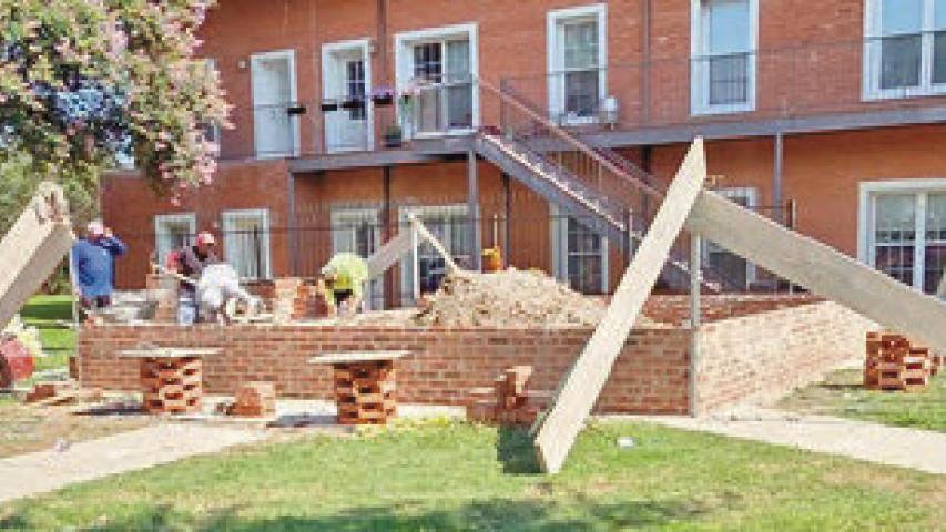 Workers lay bricks for the foundation of the new pavilion at Veterans Park in downtown Welsh. Officials are seeking donations to help fund the project. Submitted photo