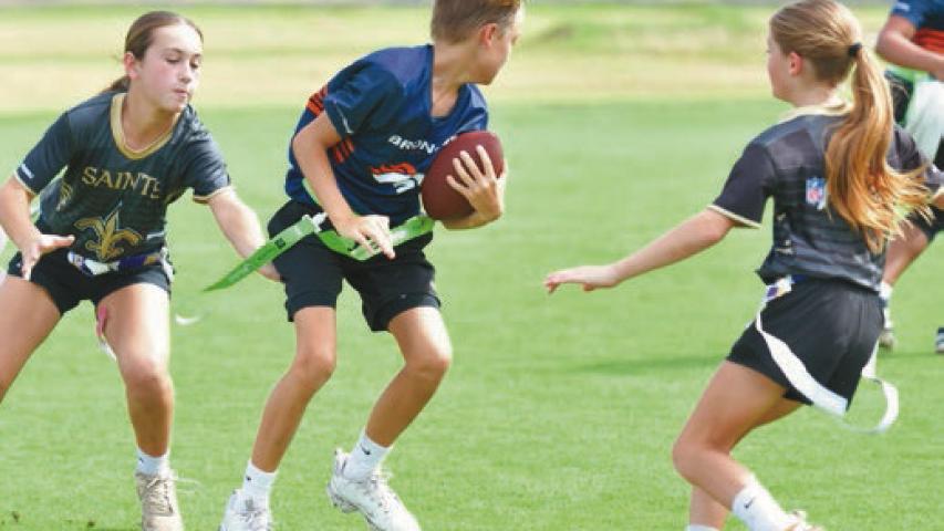 Young players participate in the opening day of the community flag football league, Next Play in Welsh. The athletes are developing their skills while enjoying a fun, active season with family and friends cheering them on. Daily News photos by Renee Benoit