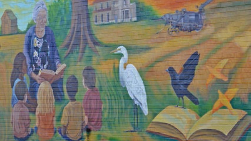 Artist Hannah Wilson spent months creating the perfect mural for the McBurney Memorial Library. Wilson has created many of the murals that can be found around the Welsh community. Daily News photo by Erin Hargrave