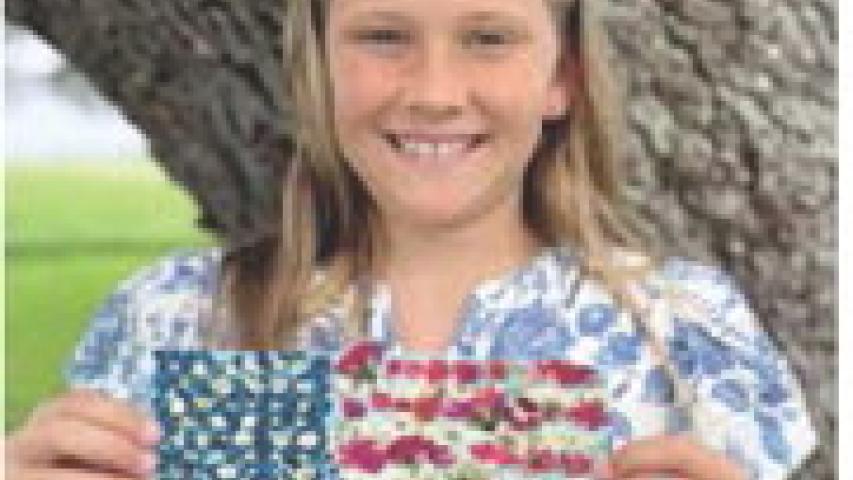 Local fourth grader Etta Landry proudly displays her work of art symbolizing what America means to her. The elementary student is the daughter of Ben and Amber Landry, the granddaughter of Tony and Sharon Comeaux, Todd and Sandy Landry and the great-granddaughter of Albert and Linda Wilson and Mary Landry, all of Jennings. Submitted photo